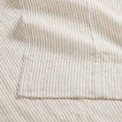 Close up of Tonic Living Siena Stripe Linen Shower Curtain showing tailored 4 inch bottom hem in ivory and beige stripe.