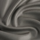 Tonic Living Smythe Faux Leather Fabric in Charcoal, a dark grey performance upholstery fabric with the rich character of genuine leather.