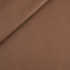 Tonic Living Smythe Faux Leather Fabric in Cognac, a deep cognac brown high-performance upholstery fabric with a natural leather look.