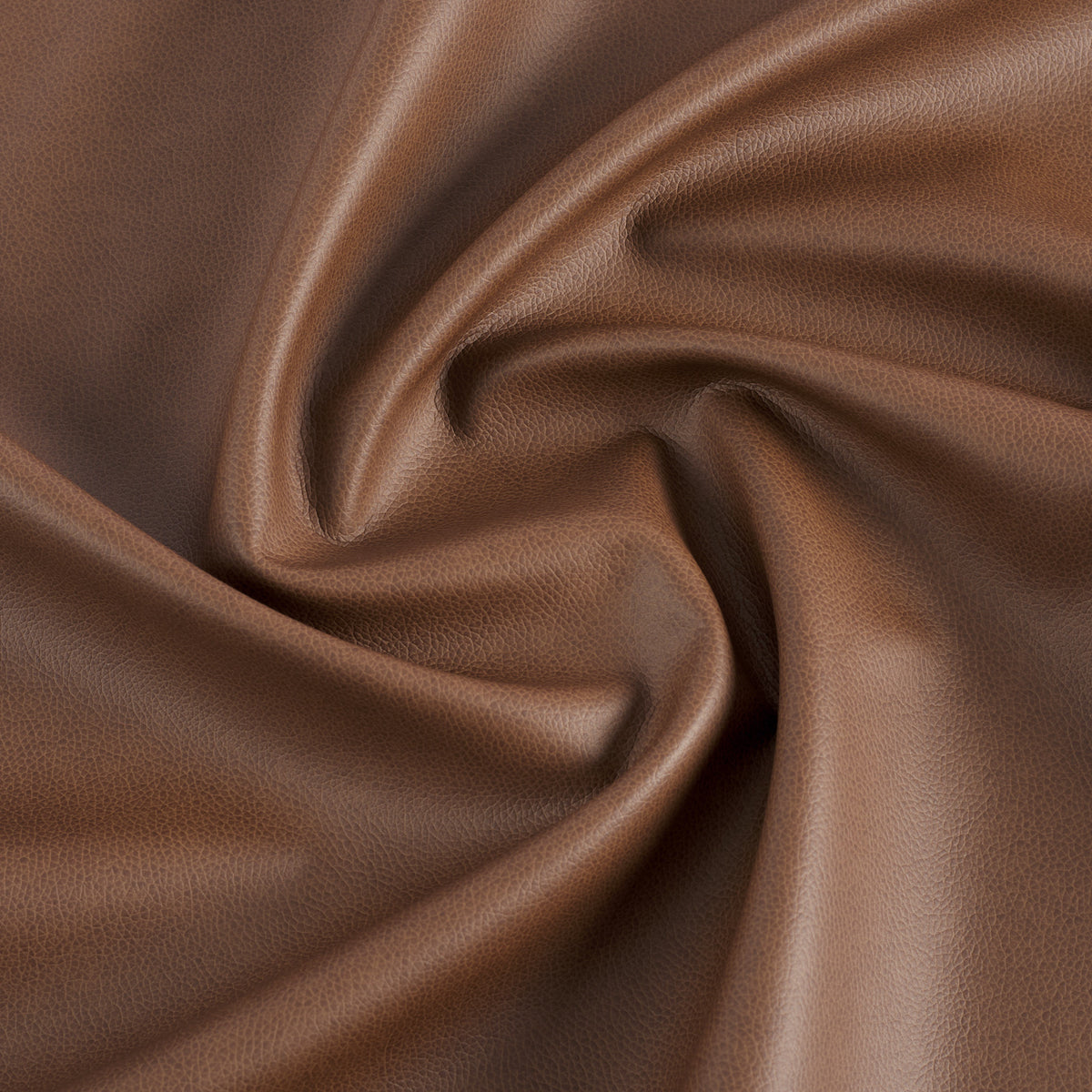 Tonic Living Smythe Faux Leather Fabric in Cognac, a deep brown performance upholstery fabric with the rich character of genuine leather.