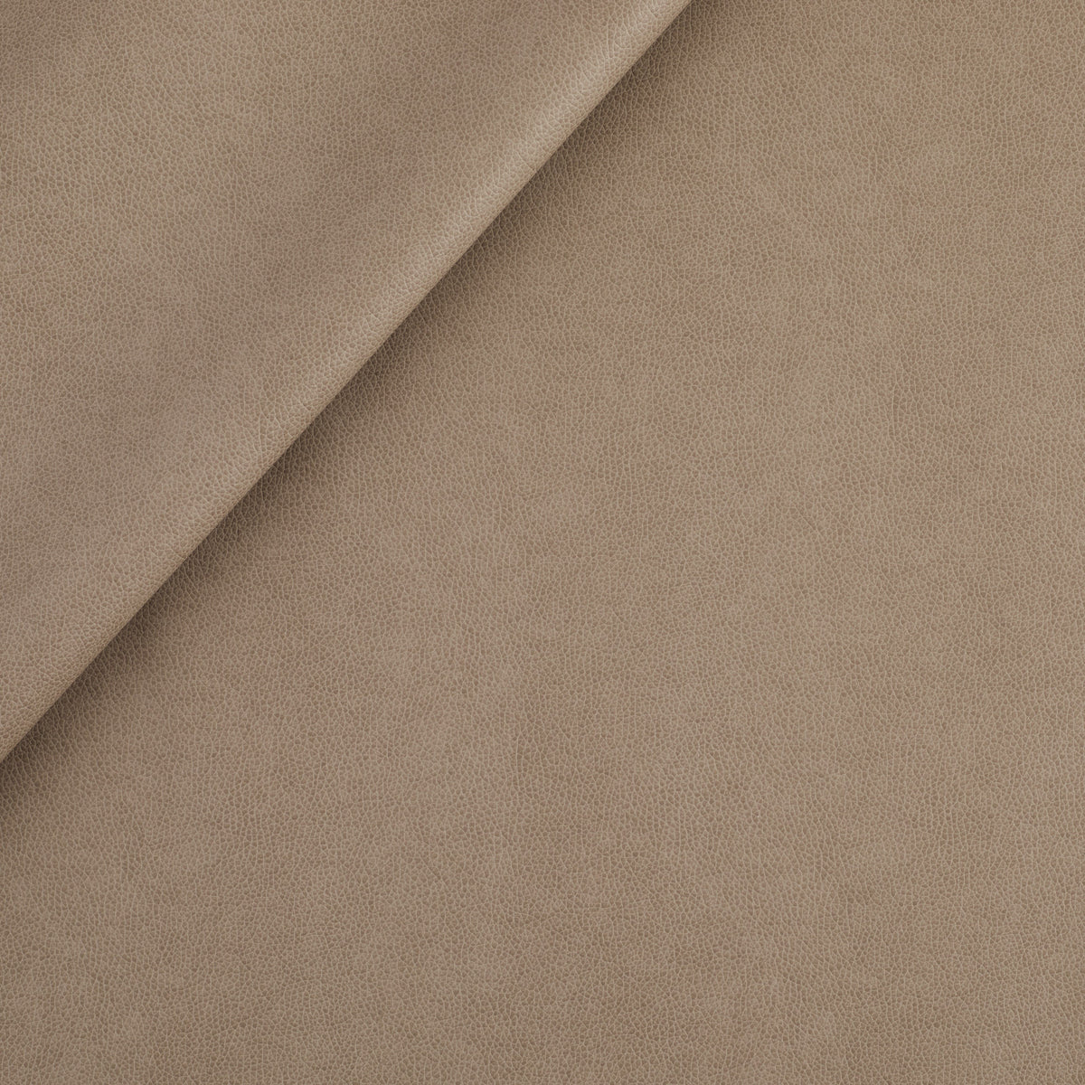 Tonic Living Smythe Faux Leather Fabric in Portobello, a taupe brown high-performance upholstery fabric with a natural leather look.