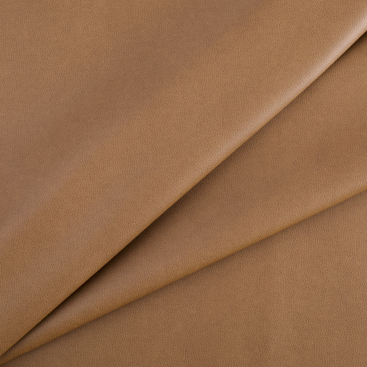 Tonic Living Smythe Saddle high-performance faux leather fabric featuring a warm brown colour and natural-looking grain.