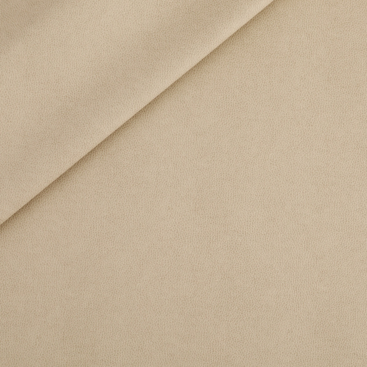 Tonic Living Smythe Faux Leather Fabric in Sandstone, a sandy beige high-performance upholstery fabric with a natural leather look.