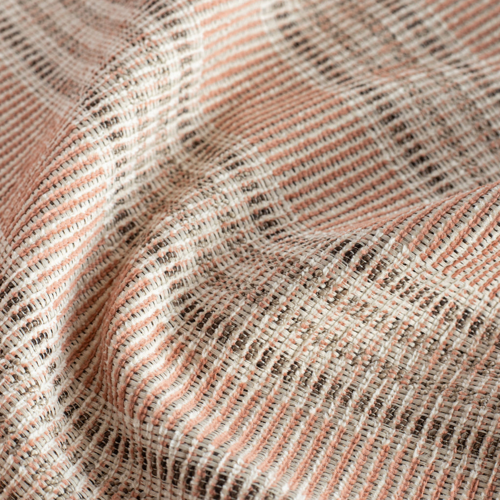 an earthy terracotta pink, brown and sand striped outdoor fabric : close up view