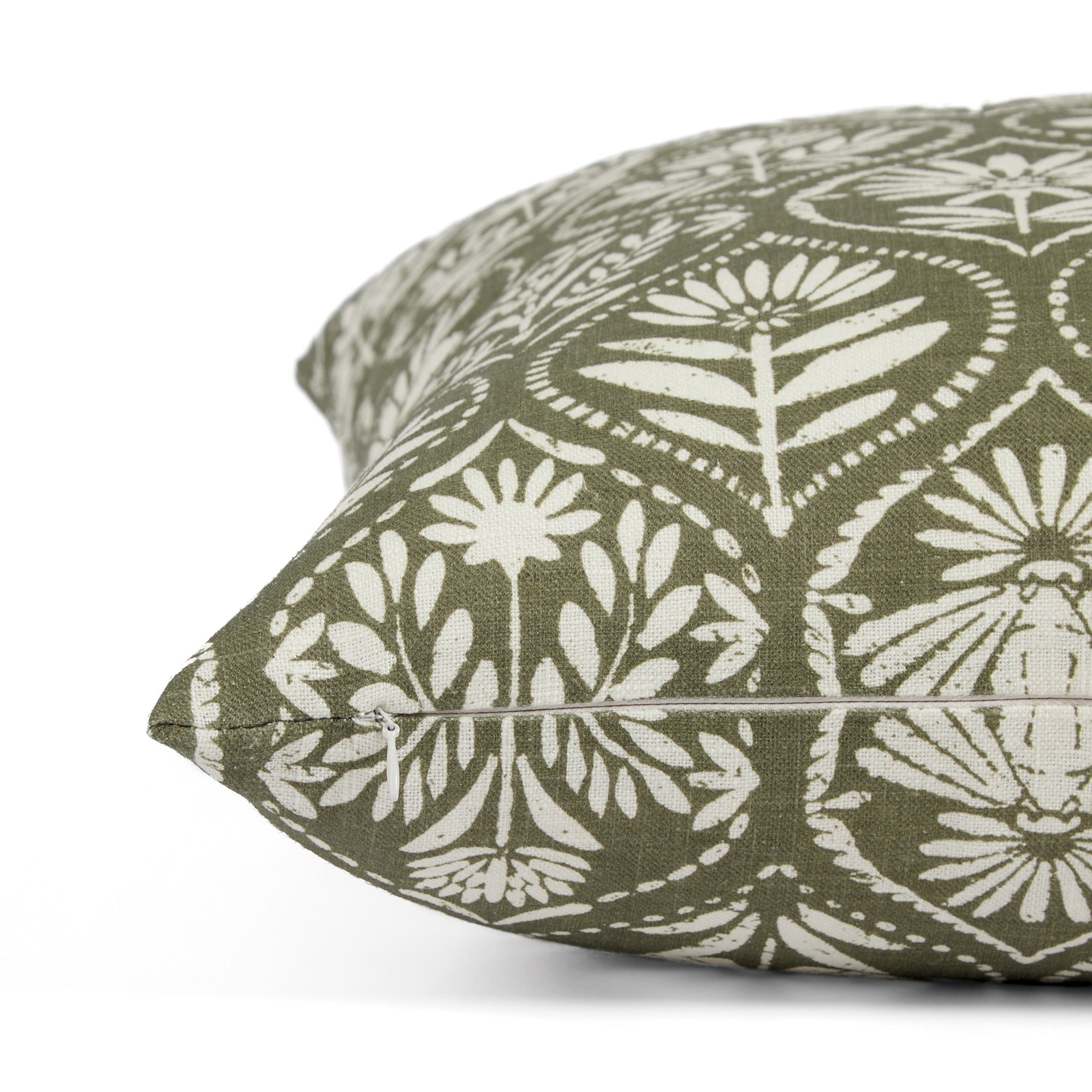 Side zipper detail of Tonic Living Stella 20x20 throw pillow in dark olive green and natural floral print.