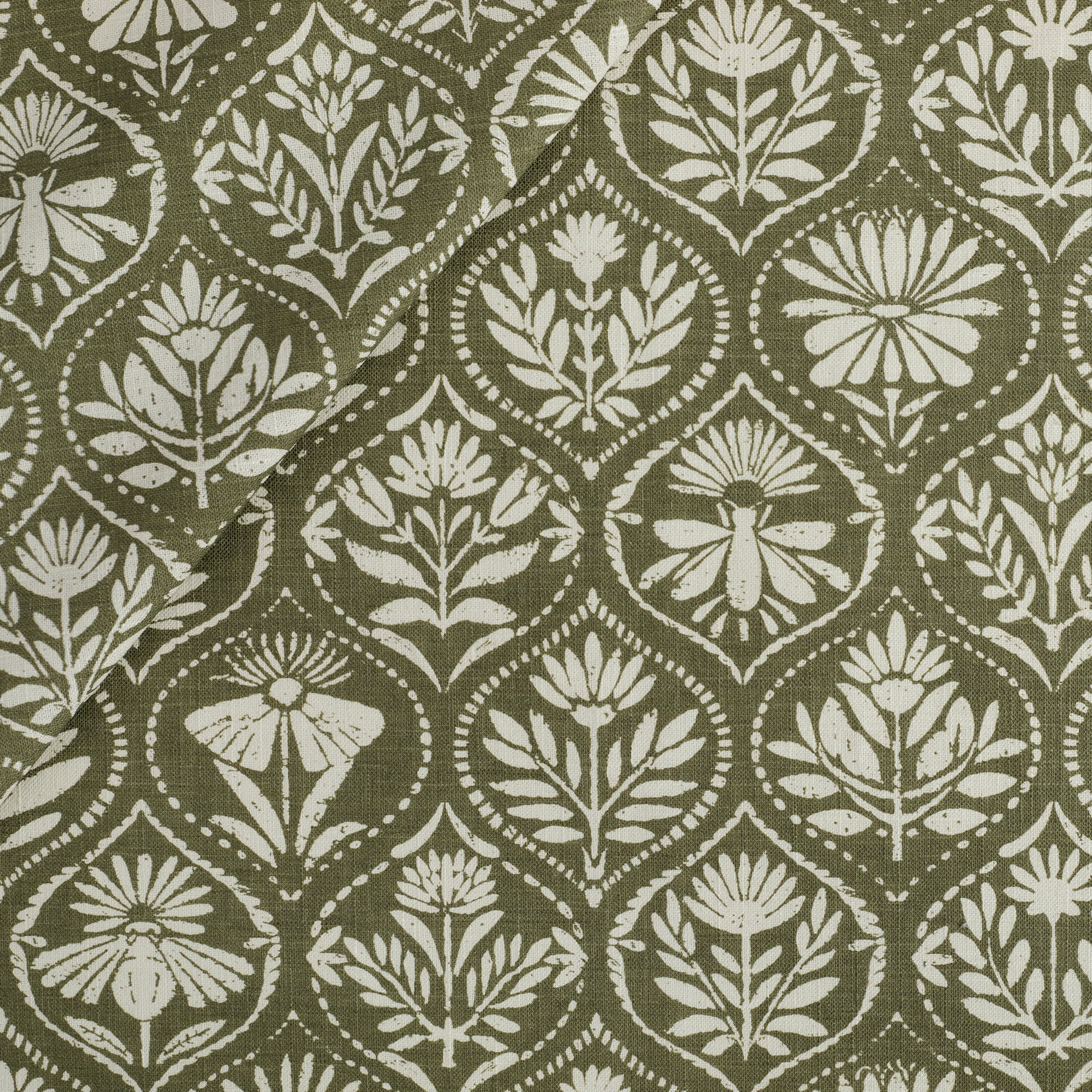 Tonic Living Stella Fabric in Evergreen, a dark olive green and beige drapery fabric with block print medallion pattern.