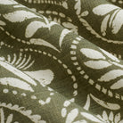 Close up of Tonic Living Stella Evergreen fabric showing olive green and beige block print medallion detail.