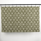Full yard of Tonic Living Stella Evergreen drapery fabric showing dark olive green and natural medallion pattern.