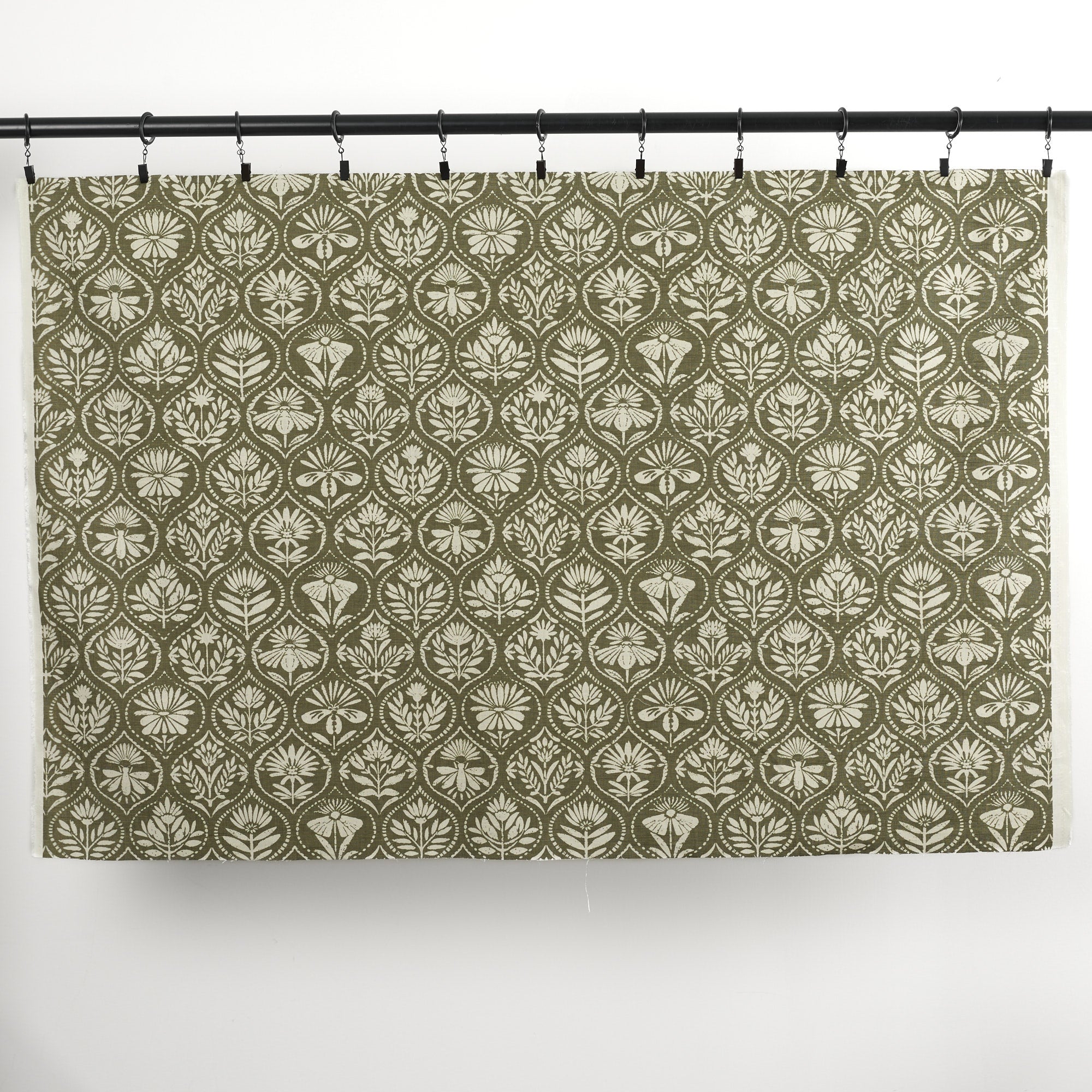 Full yard of Tonic Living Stella Evergreen drapery fabric showing dark olive green and natural medallion pattern.