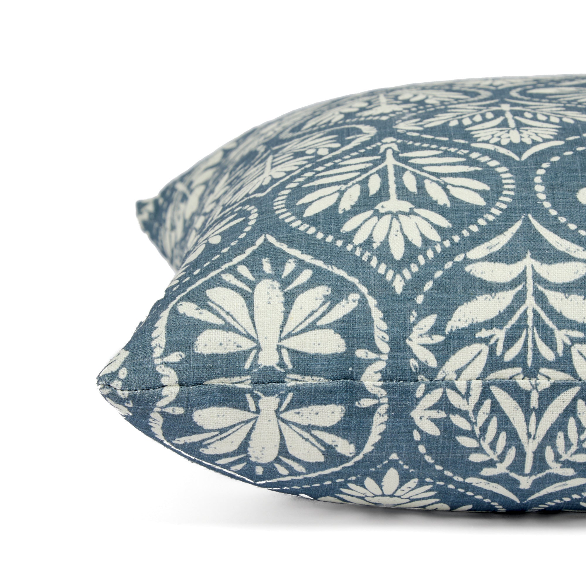 Side view of Tonic Living Stella Harbour Blue decorative pillow highlighting its floral block print medallion pattern.