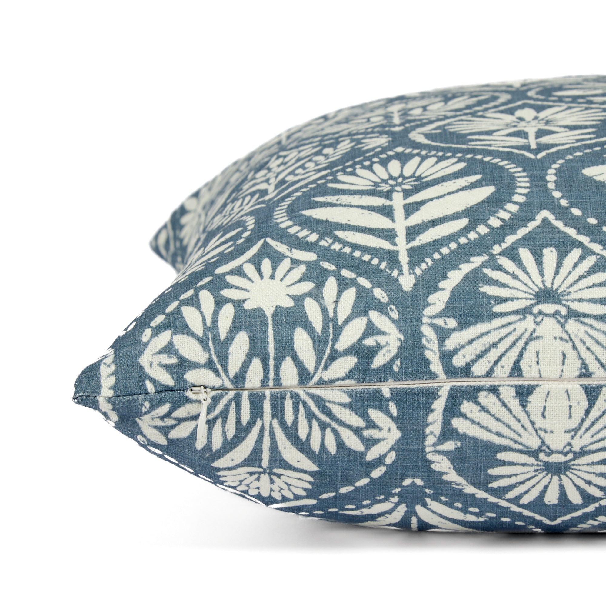 Side zipper detail of Tonic Living Stella 20x20 throw pillow in blue and natural floral print.