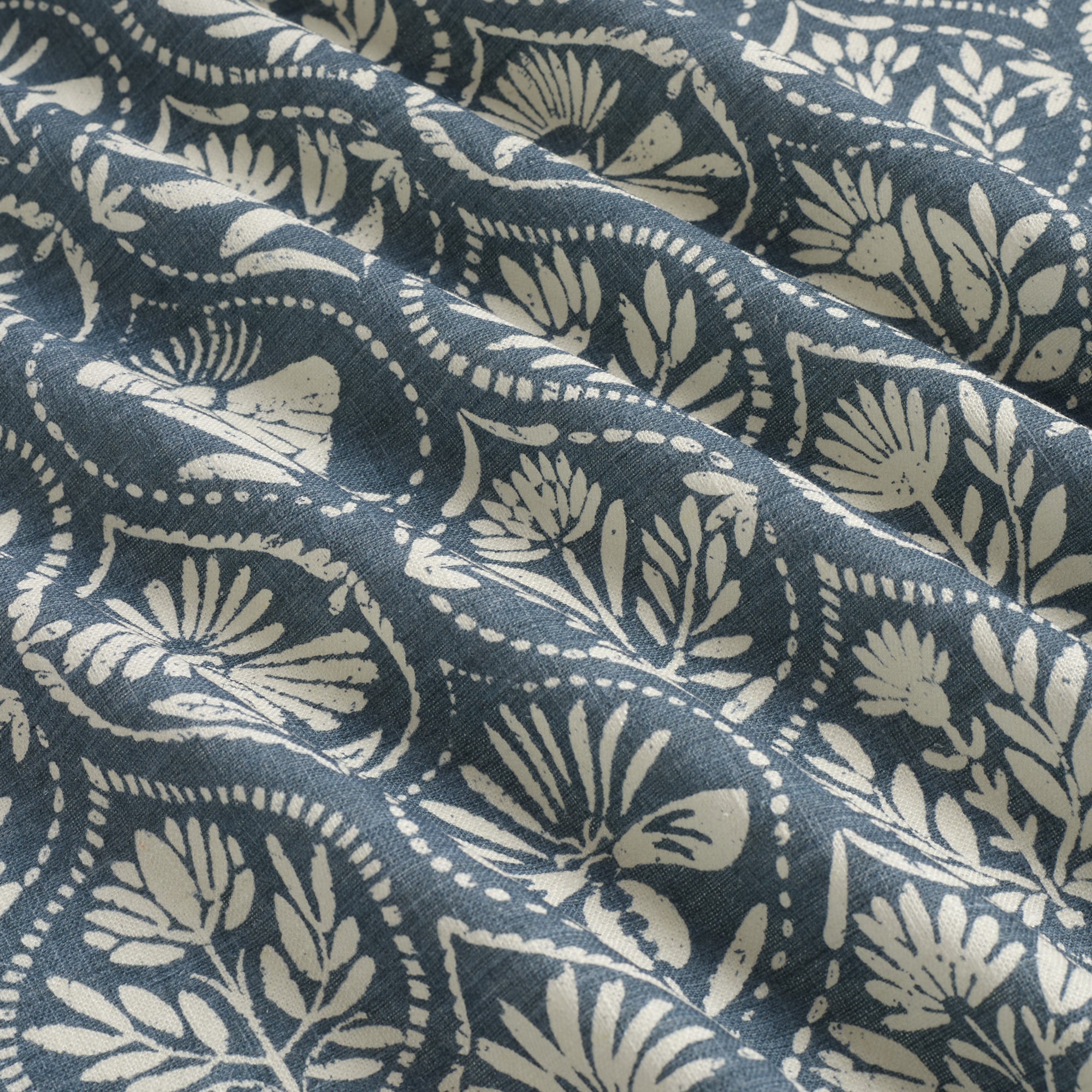 Tonic Living Stella Harbour Blue drapery fabric shown with movement highlighting blue and natural medallion pattern.