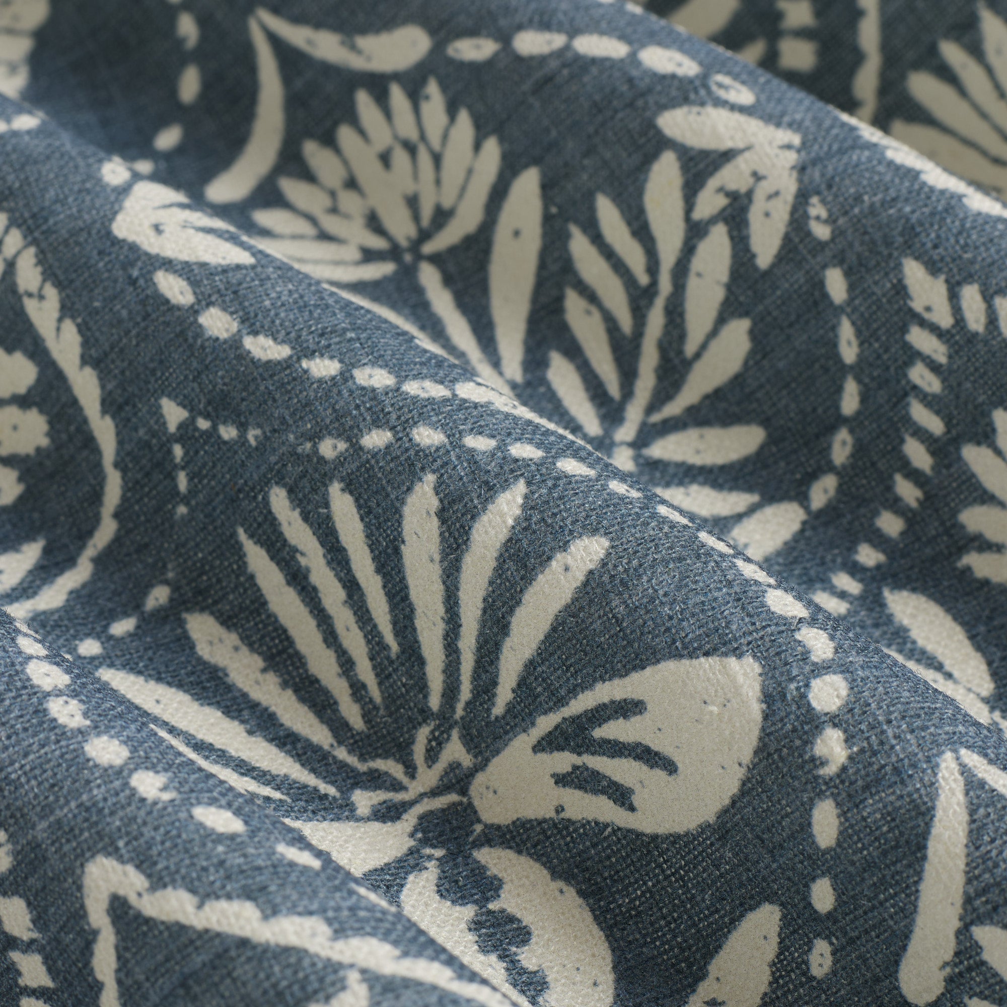 Close up of Tonic Living Stella Harbour Blue fabric showing slate blue and natural block print medallion detail.