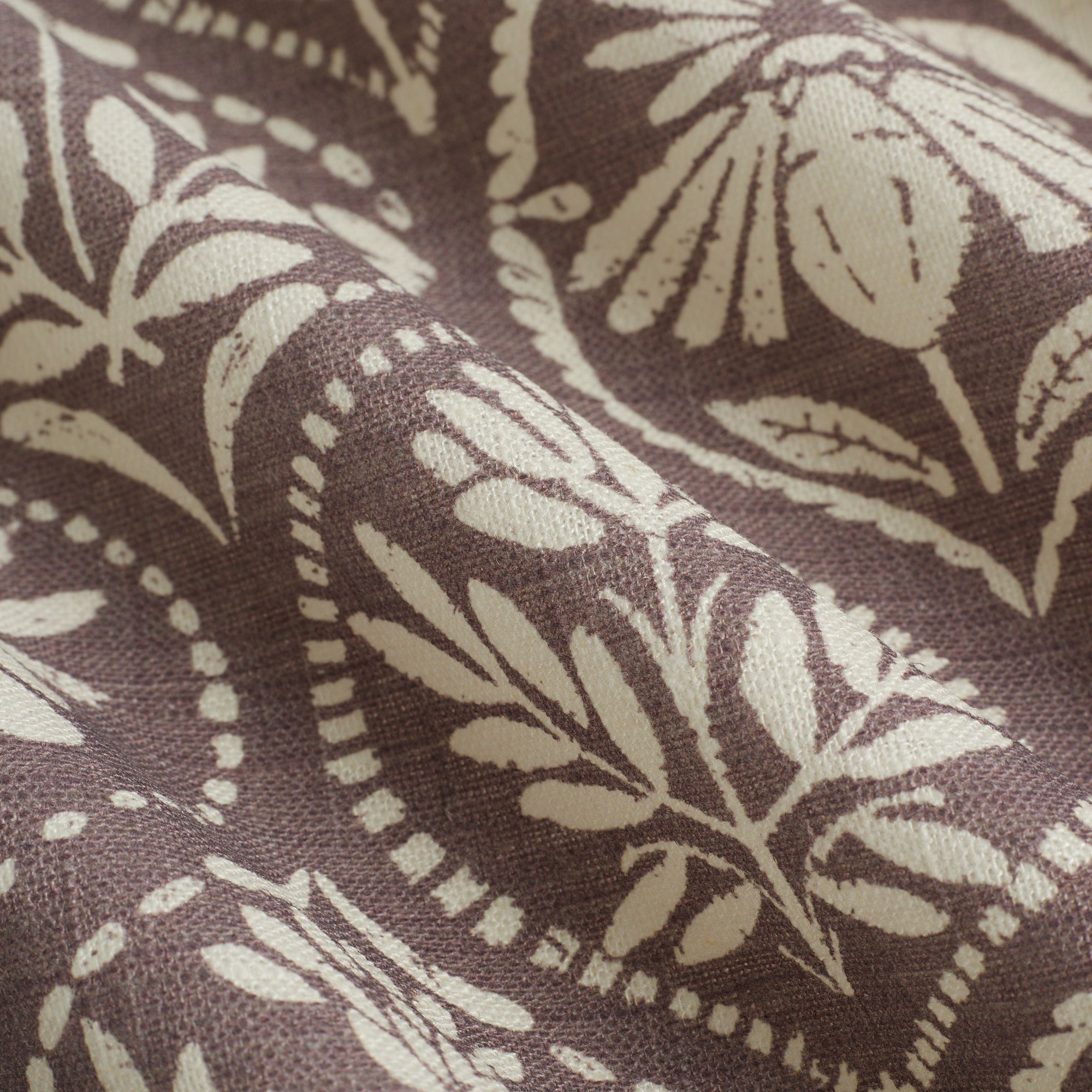 Close up of Tonic Living Stella Mauve fabric showing mauve and beige block print medallion detail.