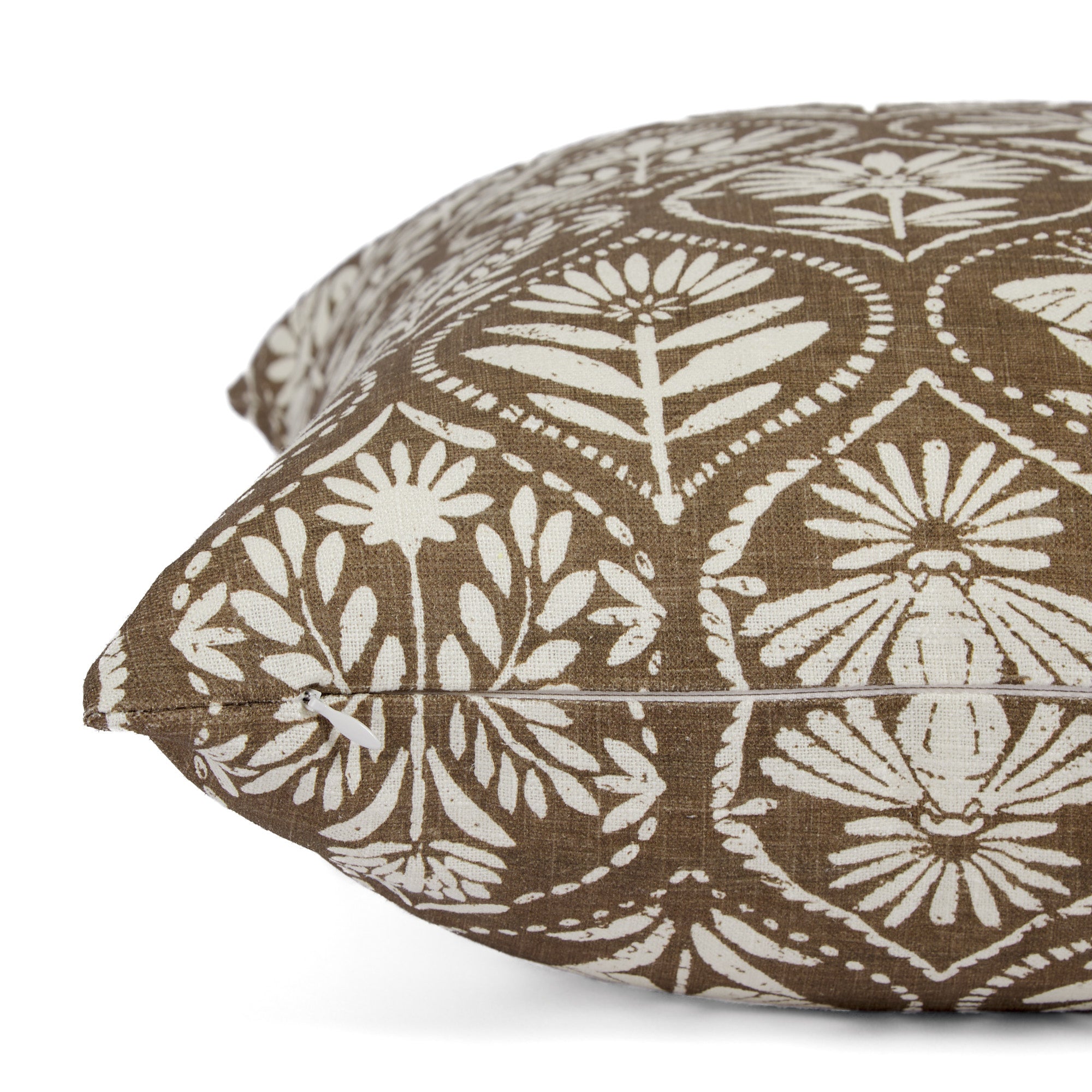 Side zipper detail of Tonic Living Stella 20x20 throw pillow in brown and natural floral print.
