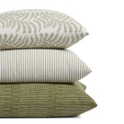 Stack of Tonic Living outdoor pillows including Swoon Sage, Refresh Hedge, and Hawthorne in green striped designs.