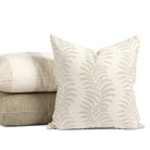 Tonic Living Swoon Sand decorative pillow styled in front of cream and brown neutral cushions.