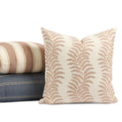 Tonic Living Sentiment Terracotta outdoor cushion styled in front of cream and blue throw pillows.