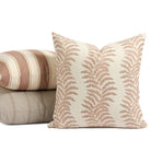 Tonic Living Swoon Terracotta outdoor pillow styled in front of neutral and terracotta cushions.