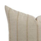 Close up of Tonic Living Talisman outdoor pillow showing sand and taupe embroidered stripe detail.