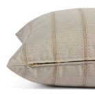 Side zipper detail of Tonic Living Talisman 22x22 outdoor toss pillow in neutral stripe.