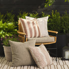 Tonic Living outdoor pillow collection styled on a patio in terracotta, white, and neutral tones.