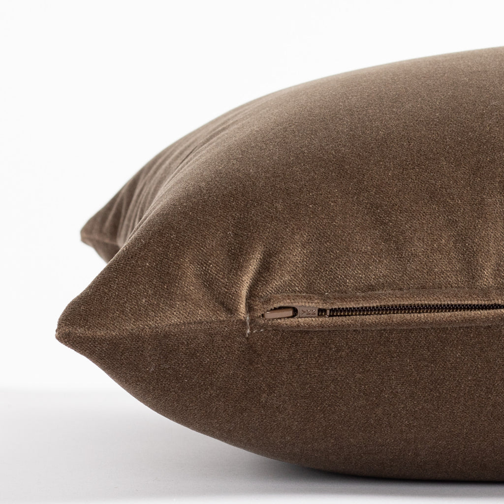 a rich brown velvet lumbar pillow - close up zipper view
