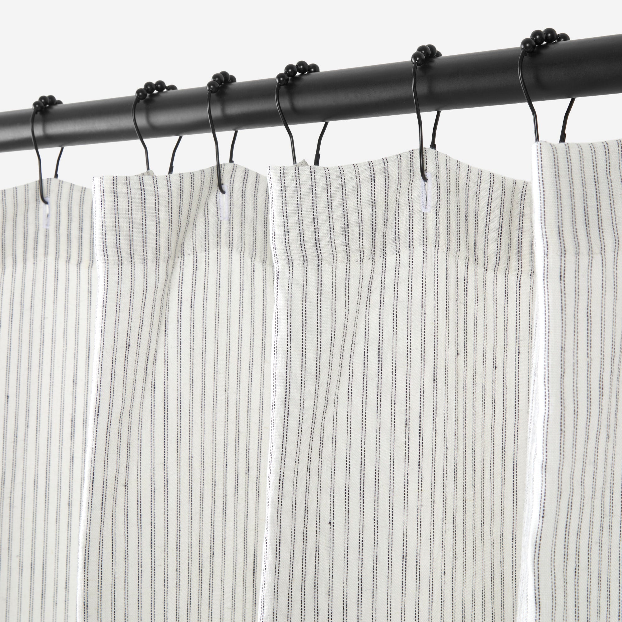 Close up of Tonic Living Verona Stripe Linen Shower Curtain showing buttonhole top in black and white stripe.
