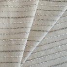 a neutral beige and gray textured striped upholstery fabric