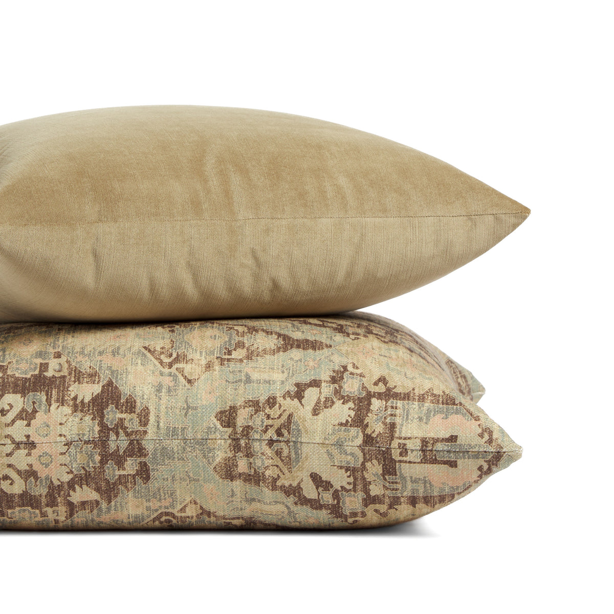 Stack of Tonic Living pillows featuring Sterling Velvet Bark in warm brown and Zuri Driftwood in a faded ornamental medallion pattern.