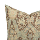 Close up of Tonic Living Zuri Driftwood pillow showing a time-worn medallion pattern in espresso, taupe, oatmeal, dusty blue, and blush.