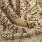 One yard of Tonic Living Zuri Driftwood multi-use fabric hanging from clips, showing the full ornamental medallion pattern.