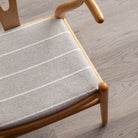 Gray striped Avalon Putty high performance upholstery fabric on a wishbone chair