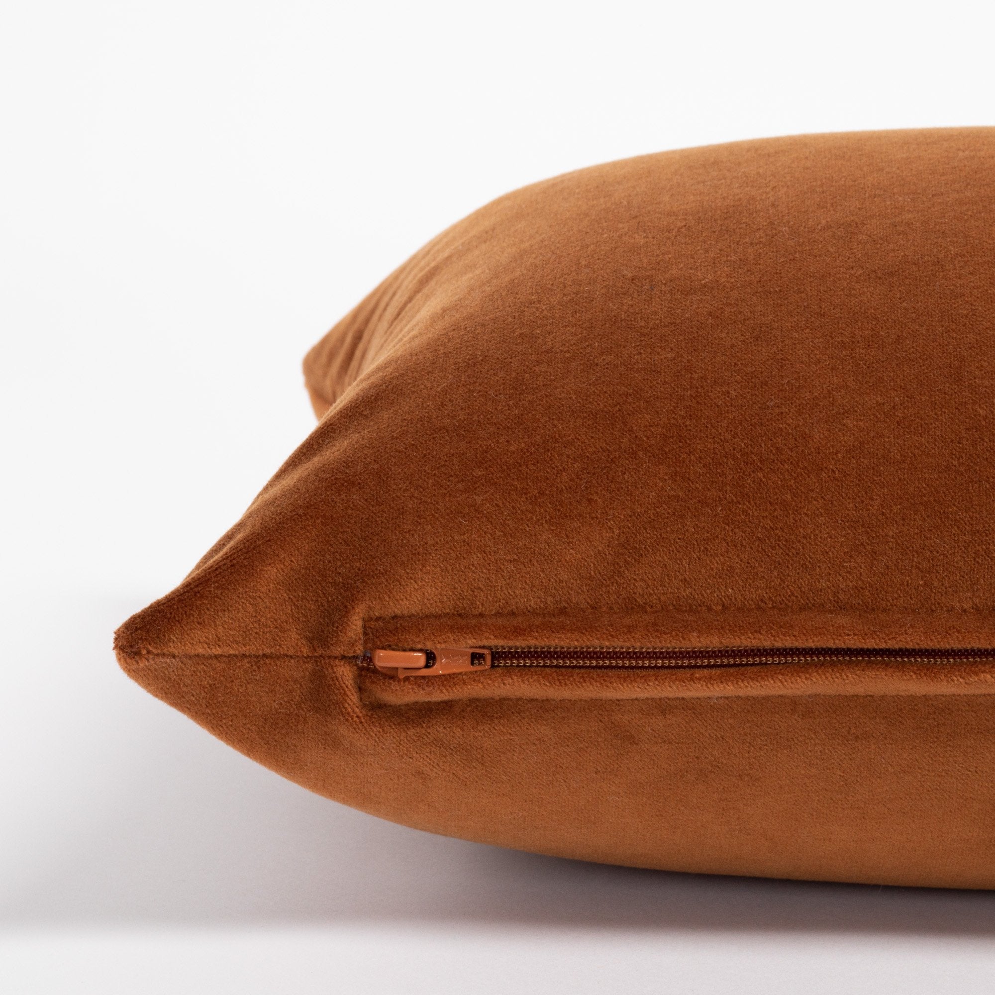 Mason Velvet 12x24 Lumbar, a rusty, burnt orange velvet lumbar pillow : close up zipper view