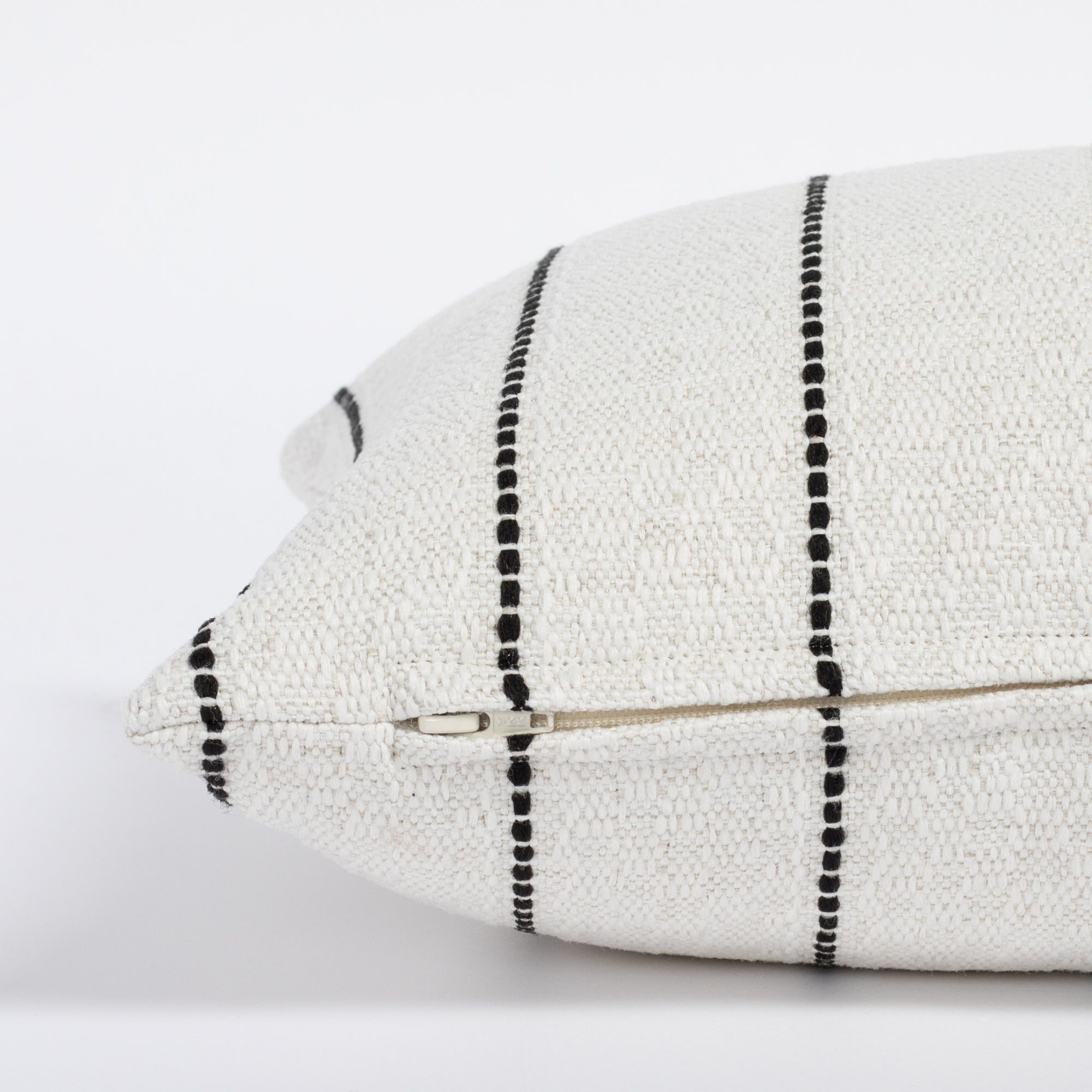 Toulouse Onyx 12x24 Lumbar Pillow, a white with black stripe lumbar pillow : close up zipper side view