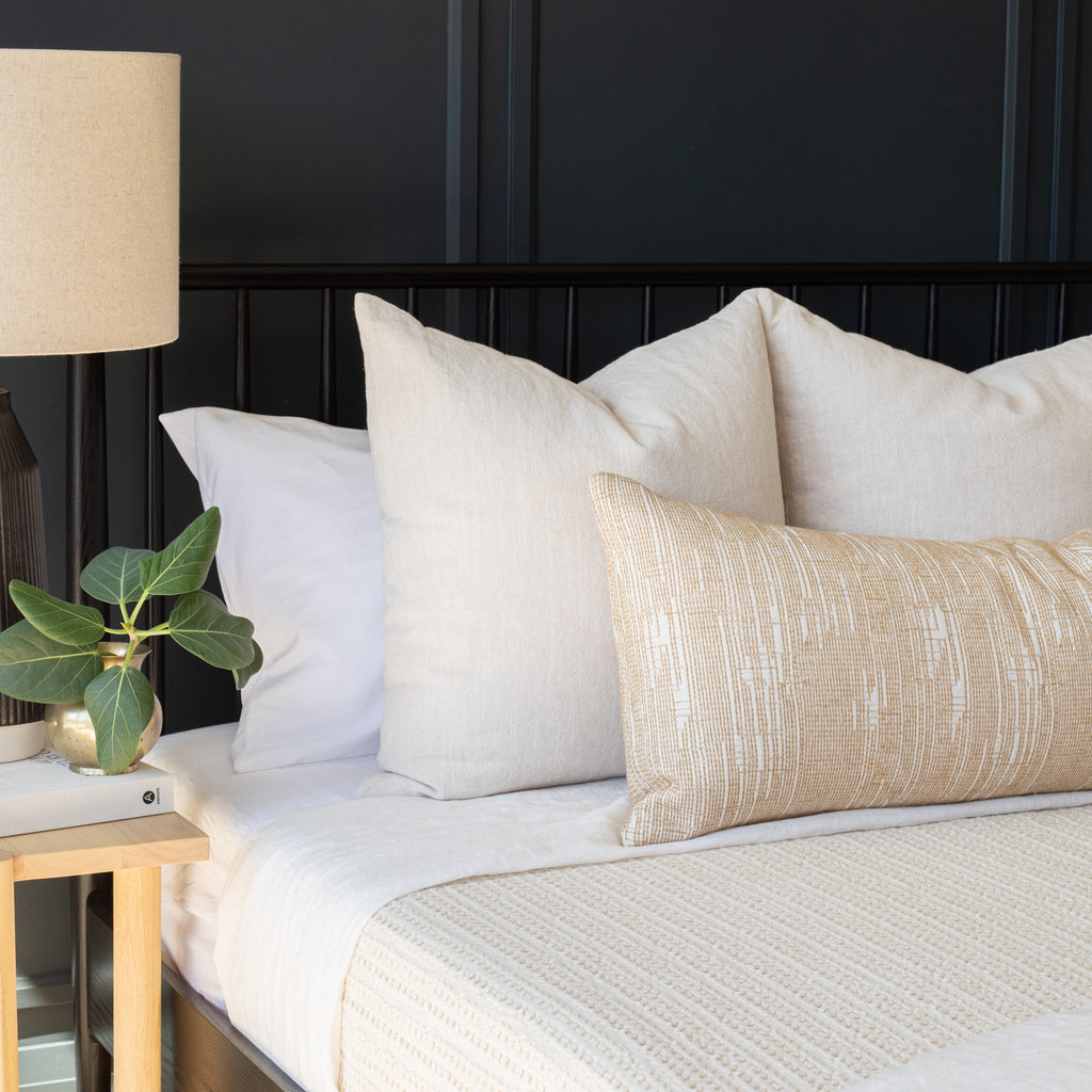 neutral throw pillows on a bed