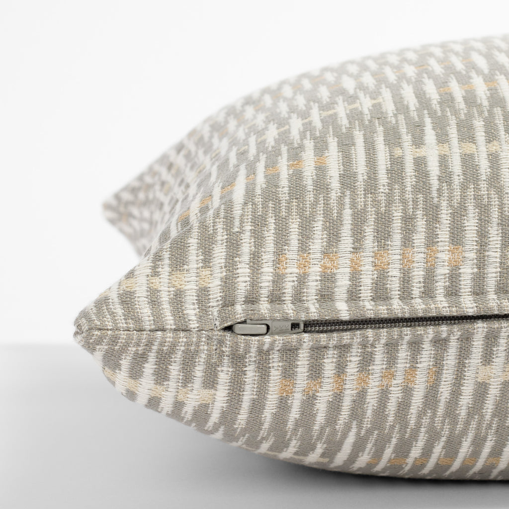 a gray, beige and cream graphic abstract pattern throw pillow : side zipper detail