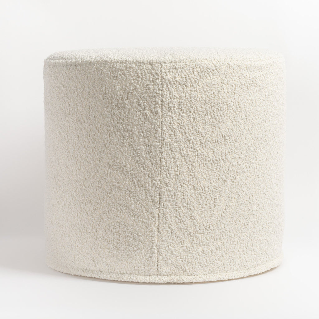 Cambie Boucle Chalk Ottoman, a creamy, off-white boucle fabric round ottoman : side with seam