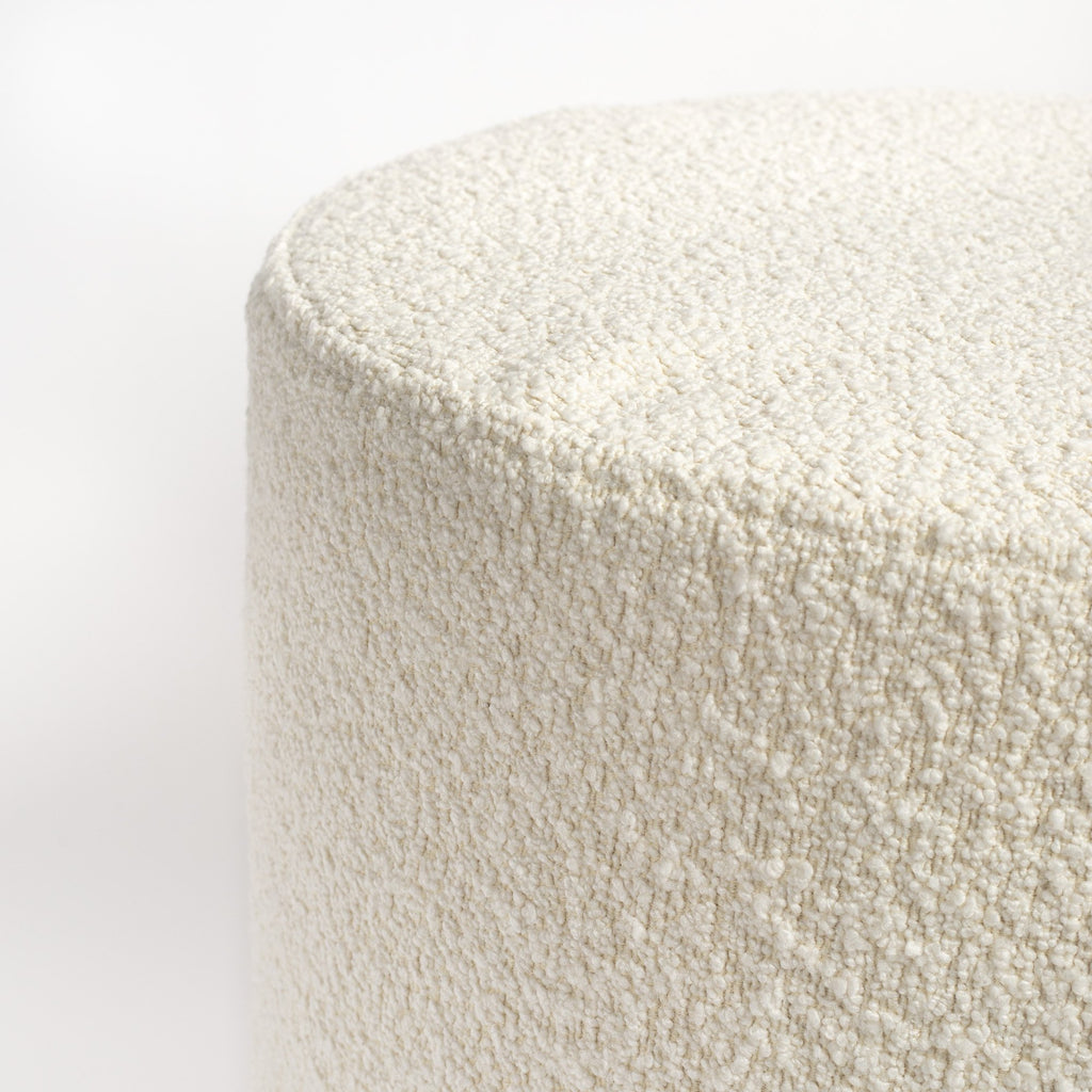 Cambie Boucle Chalk Ottoman, a creamy, off-white boucle fabric round ottoman : close up top