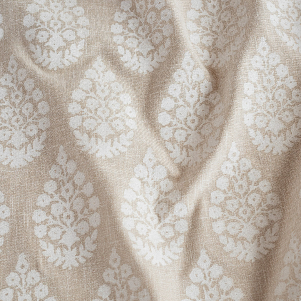 a white and beige floral block print fabric : close up 3