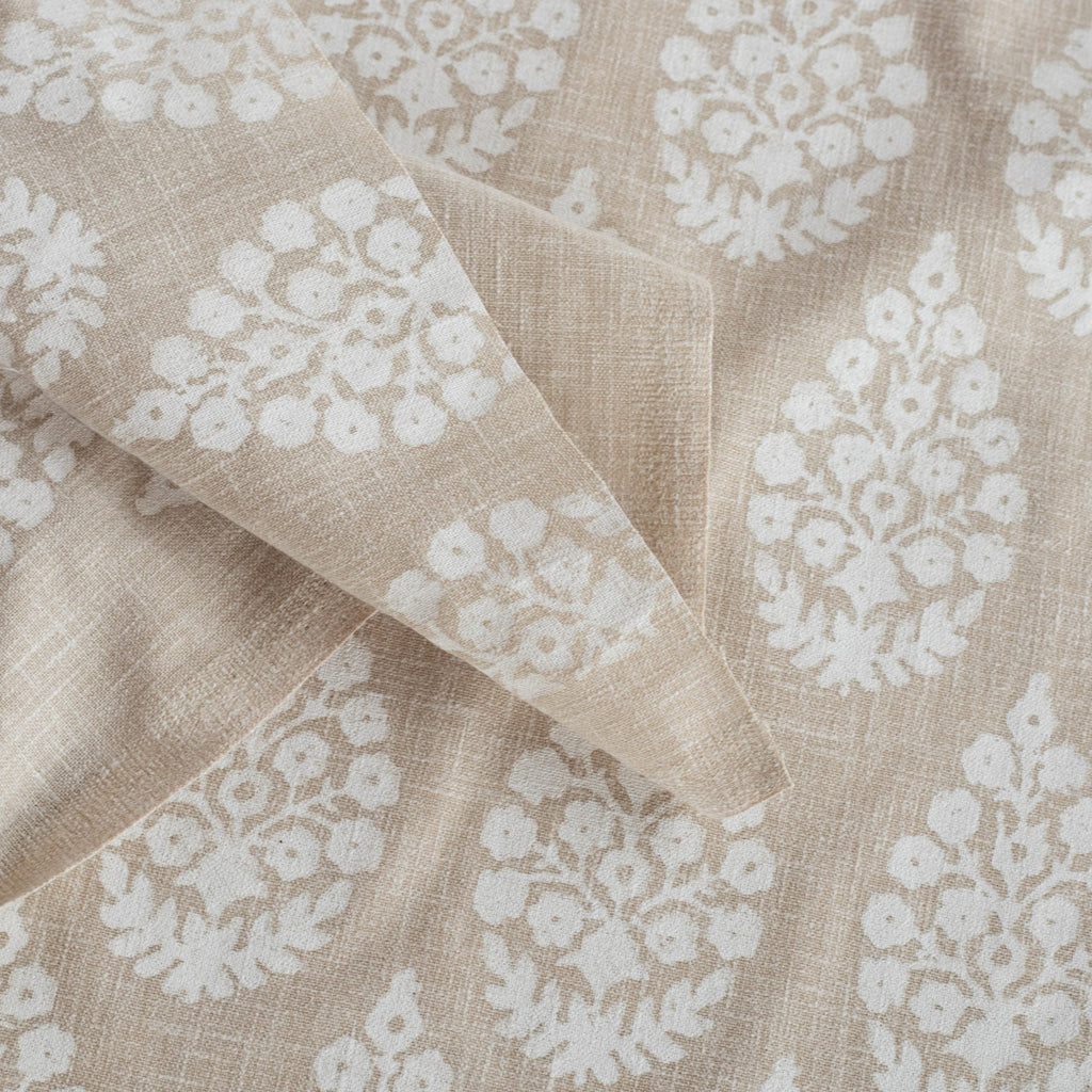 a white and beige floral block print fabric : close up 2