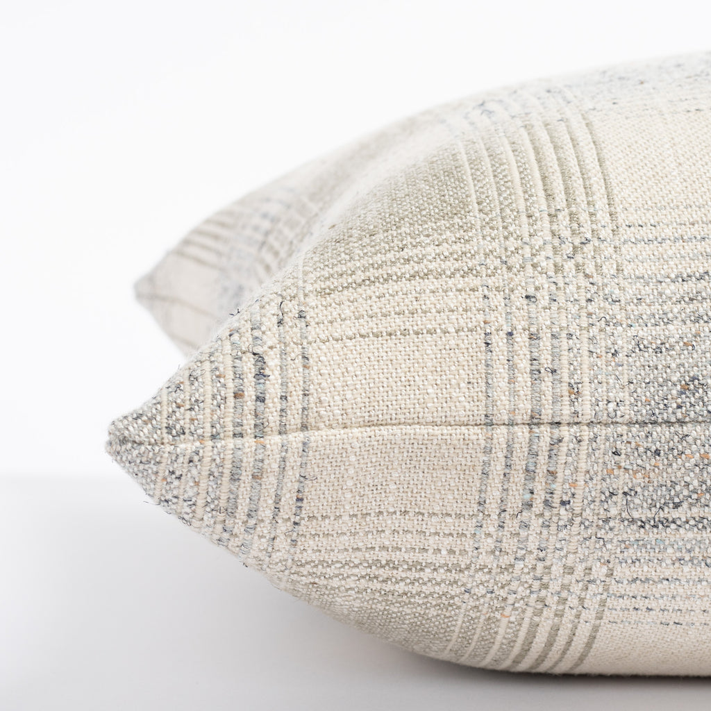 a light grey and denim blue plaid throw pillow : close up side view