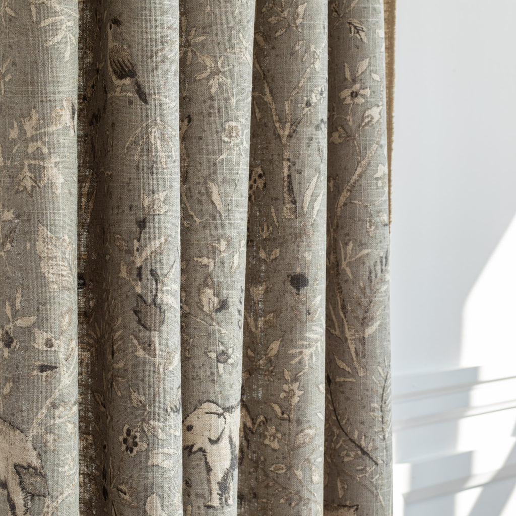 a grey botanical and exotic animal patterned drapery fabric