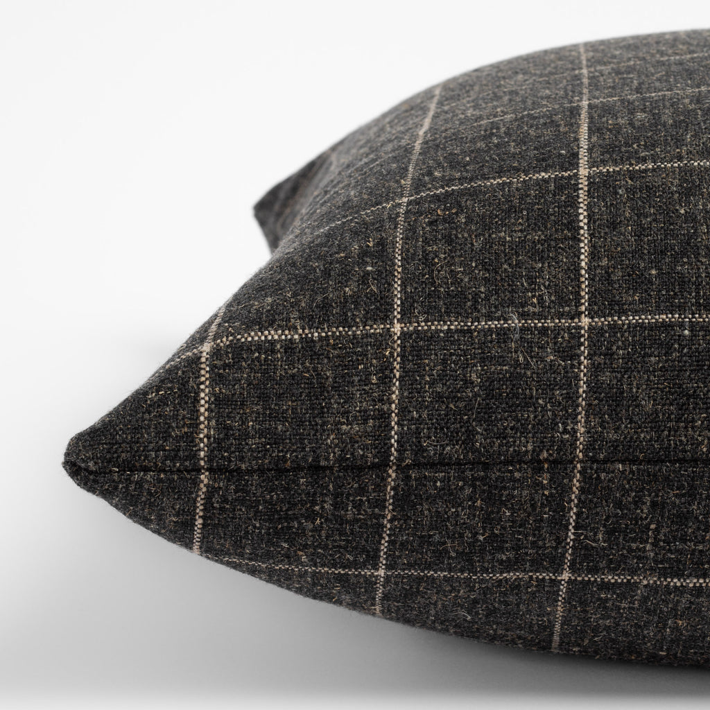 Dundee Sable, a charcoal grey and natural windowpane pillow : close up side view