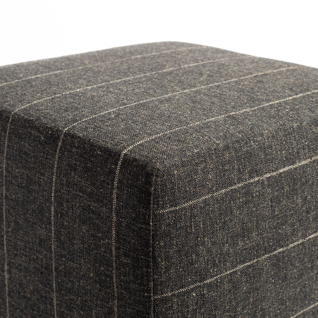a charcoal gray and tan stripe cube ottoman : corner detail shot