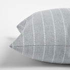 Fontana Cloud 20x20 pillow, a pale blue gray and white vertical stripe indoor outdoor pillow : close up side view