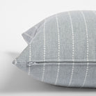 Fontana Cloud 20x20 pillow, a pale blue gray and white vertical stripe indoor outdoor pillow : close up side view