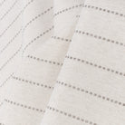 a light cream and sandy gray stripe indoor outdoor fabric :  close up view