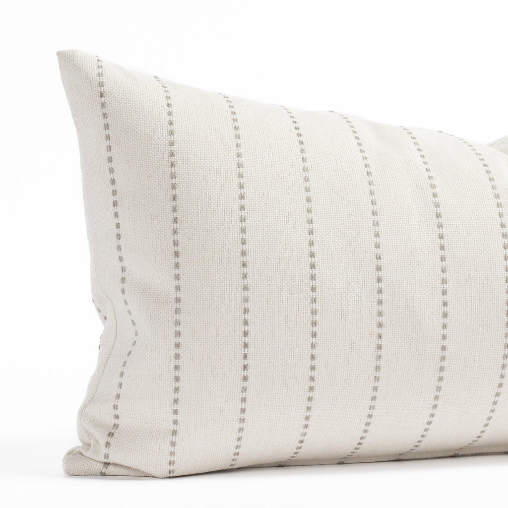 a cream and gray vertical striped indoor outdoor lumbar throw pillow 