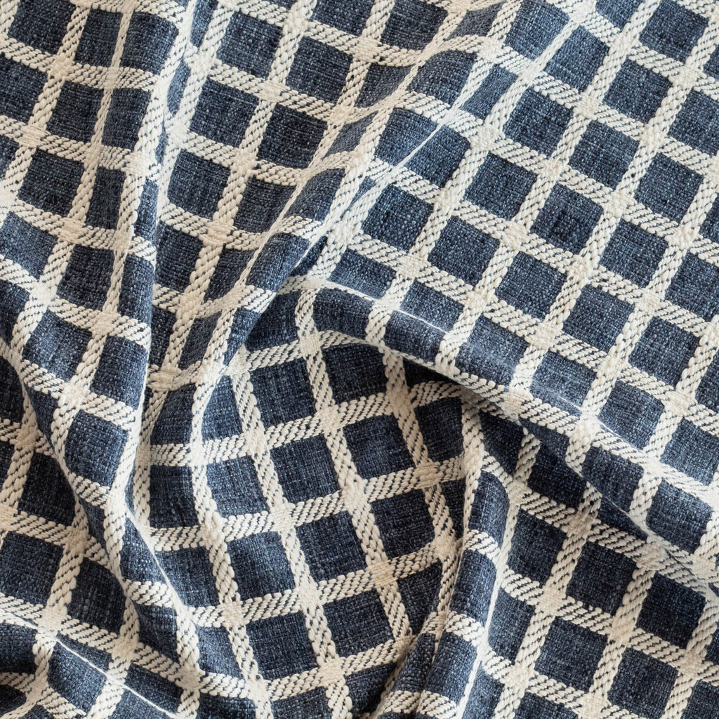 a navy blue and cream windowpane check upholstery fabric